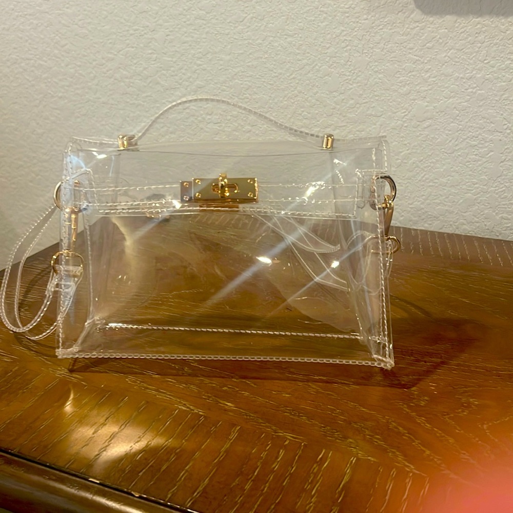 Flawless Clear bag with adjustable strap. Gold accents. Never used.